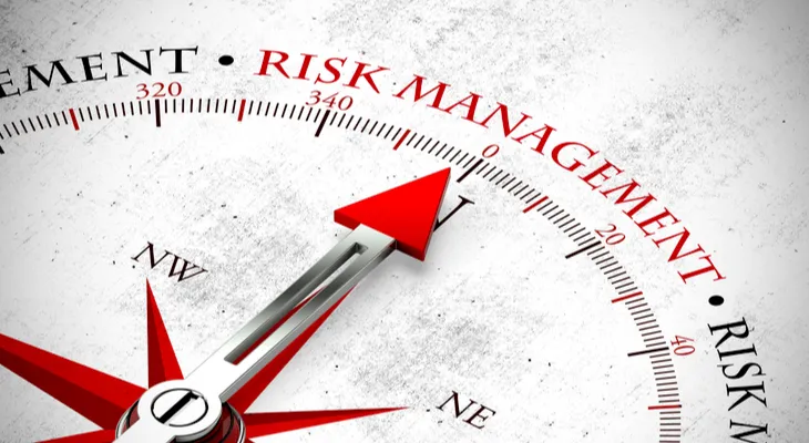 Compass needle pointing to the words risk management